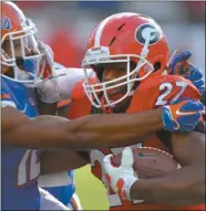  ?? Brant Sanderlin/ AP ?? Georgia running back Nick Chubb is brought down by Florida defensive back Quincy Wilson during Saturday’s game.