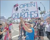  ?? Allen J. Schaben Los Angeles Times ?? PROTESTERS like these in Huntington Beach on May 1 have turned up the pressure to reopen California churches, as did President Trump on Friday.