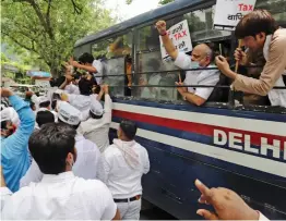  ??  ?? Police detains AAP workers who were staging a protest outside the BJP office over alleged corruption in the BJP-ruled MCDs in New Delhi on Wednesday. —
G.N. JHA