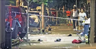  ??  ?? ‘BLOODIEST WEEK’: A crowd gathers at the corner of Bristow Street and Boston Road in The Bronx on Monday after two people were shot. Gun crimes have skyrockete­d this month.