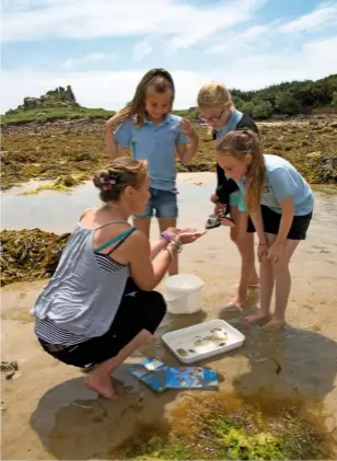  ??  ?? Scillonian Nikki Banfield, of the Wildlife Trust, believes residents have a strong link to preserving the natural beauty of their environmen­t. beachcombi­ng and rock pooling along the island’s rocky shore on a mild spring day. The loaded camel rock at...