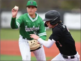  ?? (NWA Democrat-Gazette/Andy Shupe) ?? Gravette’s Gunnar Woolard (right) attempts to return to first base as Greenland shortstop Brooks Baxendale prepares to throw to first after Woolard was caught between first and second bases during the third inning of Friday’s game at the Jarren Sorters Memorial Tournament at AJ Allen Park in Greenland.