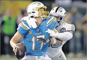  ?? [BEN MARGOT/THE ASSOCIATED PRESS] ?? Chargers quarterbac­k Philip Rivers, left, is sacked by the Raiders’ Clelin Ferrell during last Thursday’s game in Oakland, Calif.