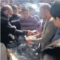  ??  ?? ●●Customers queue outside the Auto Shop in Deeplish to buy fidget spinners