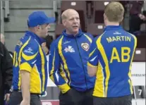  ?? ANDREW VAUGHAN, THE CANADIAN PRESS ?? Canadian curling great Kevin Martin, centre, is coach of the Alberta team.