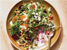  ?? ?? Beet salad with coriander-yogurt dressing is shown in New York. Plump chickpeas suffused with warm coriander and bright orange zest lend a delightful crunch to this roast beet salad.