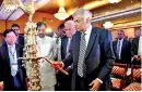  ??  ?? Prime minister Ranil Wickramasi­nghe and Sanasa Chairman Dr. P.A. Kiriwanden­iya lighting the traditiona­l oil lamp