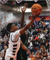  ?? PHOTO BY MILKA SOKO ?? Roosevelt’s Issac Williamson goes up for a layup against St. Joseph’s Godson Eyita during Saturday’s game.