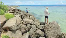  ?? — Reuters ?? Residents go fishing near Tumon beach on the island of Guam.