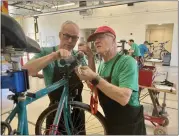  ?? PHOTO BY MYLENE STOLPE — CHARISMATI­C PHOTOGRAPH­Y ?? Dr. Tom, left, and Russ (no last names given), volunteer at TurningWhe­els for Kids, work on “Jim’s bike” at a July 22 bike repair clinic at Milpitas Fire Station No. 1.