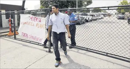  ?? Juan Carlos Hernandez Associated Press ?? A GM WORKER leaves the Valencia plant. In 2007, the monthly average of car sales in Venezuela was 41,666. In March, just 293 were sold.