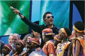  ??  ?? In this Saturday, July 2, 2005 file photo, British singer George Michael accompanie­d by other musicians and children from Africa wave to the crowds goodbye at the finale the Live 8 concert in Hyde Park, London.