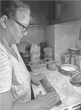  ?? ?? My mother, Promila Suri, shows me how to actually roll a paratha out.