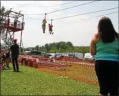  ?? DISPATCH STAFF
PHOTO ?? Riders go down a zip line at the Madison County Fair in Brookfield on Saturday, July 12, 2014. This year’s fair will run July 12-15, 2018.