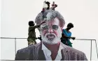  ??  ?? Indian fans pour milk to bless a cut-out image of Bollywood star Rajinikant­h outside a cinema on the first day of release of his new Tamil-language film "Kabali" in Chennai on July 22. AFP