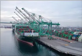  ?? PHOTO BY CHUCK BENNETT ?? Port of Los Angeles Cargo ship is docked at a port terminal in December.