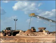  ?? Arkansas Democrat-Gazette/STATON BREIDENTHA­L ?? sand last month at Southweste­rn Energy’s facility in North Little Rock where dredged sand is prepared for shipping.