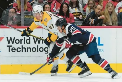  ?? SUSAN WALSH/AP ?? New Capitals defenseman Ethan Bear, right, looked comfortabl­e right away against the Predators on Saturday, and it took him only a handful of shifts to feel settled.