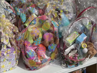  ?? PHOTOS BY MARAH MORRISON — THE NEWS-HERALD ?? Easter baskets that were donated by Century 21Asa Cox homes and Easter eggs filled with candy were added to the picture at a monthly free grab and go lunch event for children and their families.