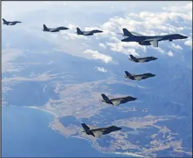  ?? South korea defense ministry via ap ?? In this photo provided by South Korea Defense Ministry, a U.S. Air Force B-1B bomber, right top, flies over the Korean Peninsula with South Korean fighter jets and U.S. fighter jets during a combined aerial exercise Wednesday.