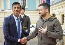  ?? UKRAINIAN PRESIDENTI­AL PRESS OFFICE VIA AP ?? Ukrainian President Volodymyr Zelenskyy (right) shakes hands with British Prime Minister Rishi Sunak during their meeting in Kyiv on Saturday.