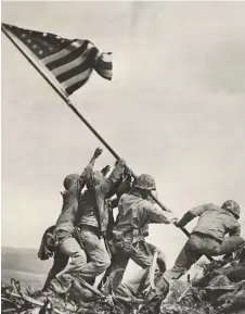  ?? — AFP photo ?? This handout photo obtained from the National Archives, shows six US soldiers raising the US flag atop Mount Suribachi on the Pacific island of Iwo Jima on Feb 23, 1945.