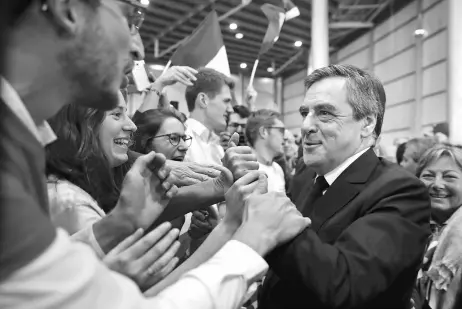  ??  ?? Fillon (right) is greeted by supporters as he arrives to attend a campaign rally in Lille, France. — Reuters photo