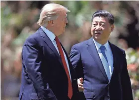  ?? ASSOCIATED PRESS ?? President Donald Trump and Chinese President Xi Jinping walk after their meetings in Palm Beach, Fla., on April 7. Trump has dropped plans to label China a currency manipulato­r.