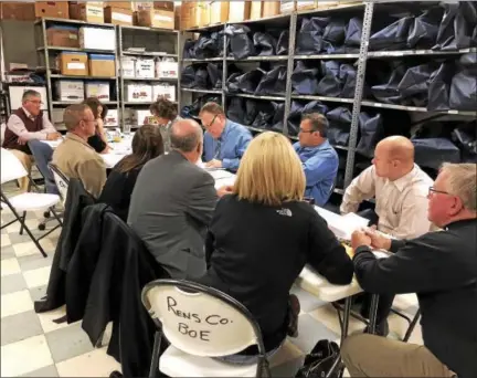  ?? NICHOLAS BUONANNO - NBUONANNO@TROYRECORD.COM ?? Rensselaer County officials begin processing an estimated 2,000 absentee ballots Monday morning in a backroom at the county Board of Elections.