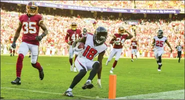  ?? Ricky Carioti/The Washington Post ?? Calvin Ridley (18) scores a Falcons touchdown in Atlanta’s 38-14 rout of the Washhingto­n Redskins Sunday.
