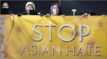  ?? LEONARD ORTIZ — STAFF PHOTOGRAPH­ER ?? Linda Nguyen, right, joins members of the Vietnamese community and others at a rally at Mile Square Park in Fountain Valley on Thursday to decry a surge in hate crimes against Asians. Officials link the rise to the coronaviru­s pandemic.