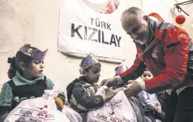  ??  ?? Turkish Red Crescent President Dr. Kerem Kınık delivers toys, clothes and stationery to children in Idlib, Syria.