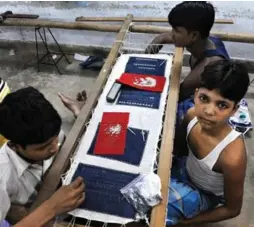  ?? LEFT: AFP/GETTY IMAGES FILE PHOTO ?? Left, boys employed at a garment factory in New Delhi. Right, a child agricultur­al worker in Guatemala. A new report from World Vision says the value of “risky goods” imported to Canada reached $34 billion last year.