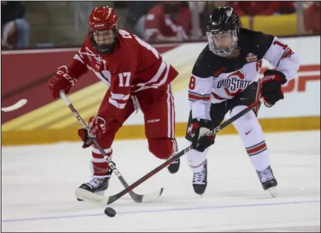 ?? CLINT AUSTIN — DULUTH NEWS TRIBUNE ?? Wisconsin forward Britta Curl skates against Ohio State defenseman Sophie Jaques during the NCAA Women’s Frozen Four Championsh­ip game Sunday in Duluth.