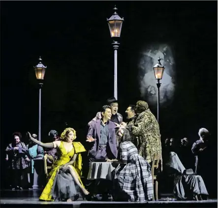  ?? Dania Maxwell Los Angeles Times ?? “LA BOHÈME” features Erica Petrocelli, seated left, as Musetta and Saimir Pirgu , standing center with his hand out, as Rodolfo.