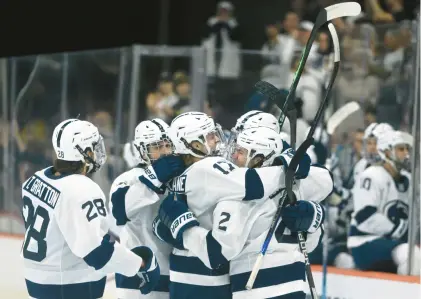  ?? RICK KINTZEL/THE MORNING CALL ?? Members of the Penn State hockey team gather around their teammate, Tyler Paquette after scoring Friday during a NCAA Division 1 Regional hockey tournament against Michigan Tech at PPL Center in Allentown.