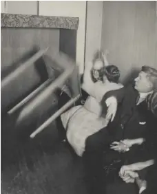  ??  ?? Above: Medium Elizabeth Poole, second from left, allegedly levitates a table during a seance in Winnipeg on March 20, 1927.