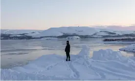  ?? Photograph: Frankie Mills/Coda Story ?? Memettursu­n Omer looks out over an icy fjord. The small Norwegian town of Kirkenes is 250 miles north of the Arctic Circle.