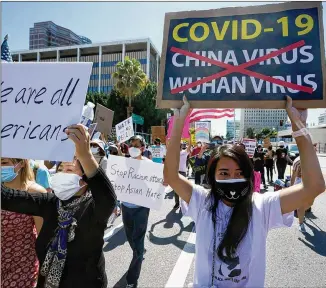  ?? DAMIAN DOVARGANES/ASSOCIATED PRESS ?? Protesters march at a rally against Asian hate crimes near the Los Angeles Federal Building last week. The crowd demanded justice for the victims of the Atlanta-area spa shootings.