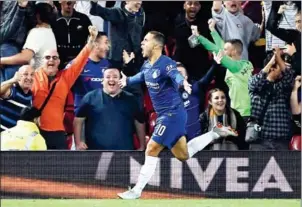  ?? PAUL ELLIS/AFP ?? Chelsea midfielder Eden Hazard celebrates scoring his team’s second goal in their English League Cup third round match at Anfield on Wednesday night.