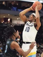  ?? Patrick McDermott / Getty Images ?? Marquette’s Justin Lewis (10) shoots over Villanova’s Brandon Slater on Wednesday.