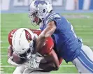  ??  ?? Lions free safety Glover Quin tackles Cardinals running back David Johnson.