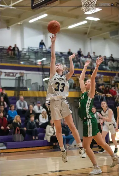  ?? TOM SILKNITTER FOR THE DAILY LOCAL NEWS ?? Rustin’s Riley Stackhouse makes a basket with Bishop Shanahan’s Abby Wolf defending during the first half.