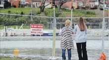  ?? DAVE JOHNSON
THE WELLAND TRIBUNE ?? In this 2017 file photo, two women look at the flooded pier at Port Dalhousie in St. Catharines. The Lake Ontario-St. Lawrence River Board released a report that said extreme weather was one of the reasons there was flooding along Lake Ontario and the...