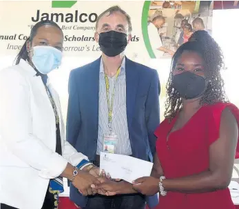  ?? JIS ?? Chief Education Officer (Acting) in the Ministry of Education and Youth, Dr Kasan Troupe (left), presents Jasmine Collins (right) with a commitment letter of education assistance from Jamalco, during a ceremony at the Halse Hall Great House in Clarendon on Wednesday. Looking on is Jamalco’s Managing Director, Austin Mooney.