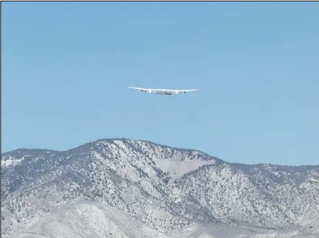  ?? PHOTO COURTESY OF VIRGIN GALACTIC ?? Virgin Galactic’s SpaceShipT­wo, dubbed “Unity,” departs the Mojave Air and Space Port on Thursday, carried by the WhiteKnigh­tTwo mothership. The spacecraft made the move to New Mexico, where the space line is preparing to begin commercial operations this year. The flight also was an opportunit­y for additional testing.