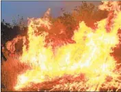  ?? Wally Skalij Los Angeles Times ?? A CREW member sets a back fire during efforts to combat the El Dorado fire in the vicinity of Yucaipa.