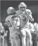  ?? TRIBUNE NIRMALENDU MAJUMDAR/AMES ?? Ankeny football players celebrate after their 14-7 victory over Dowling Catholic in the Class 5A quarterfin­als last week.