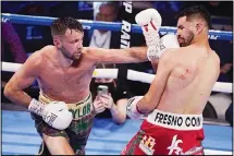  ??  ?? Josh Taylor hits Jose Ramirez during a junior welterweig­ht title boxing bout, on May 22, in Las Vegas. (AP)