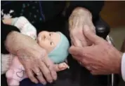  ?? CARLOS OSORIO — THE ASSOCIATED PRESS FILE ?? A son, at right, holds his mother’s hand at her nursing home in Michigan.